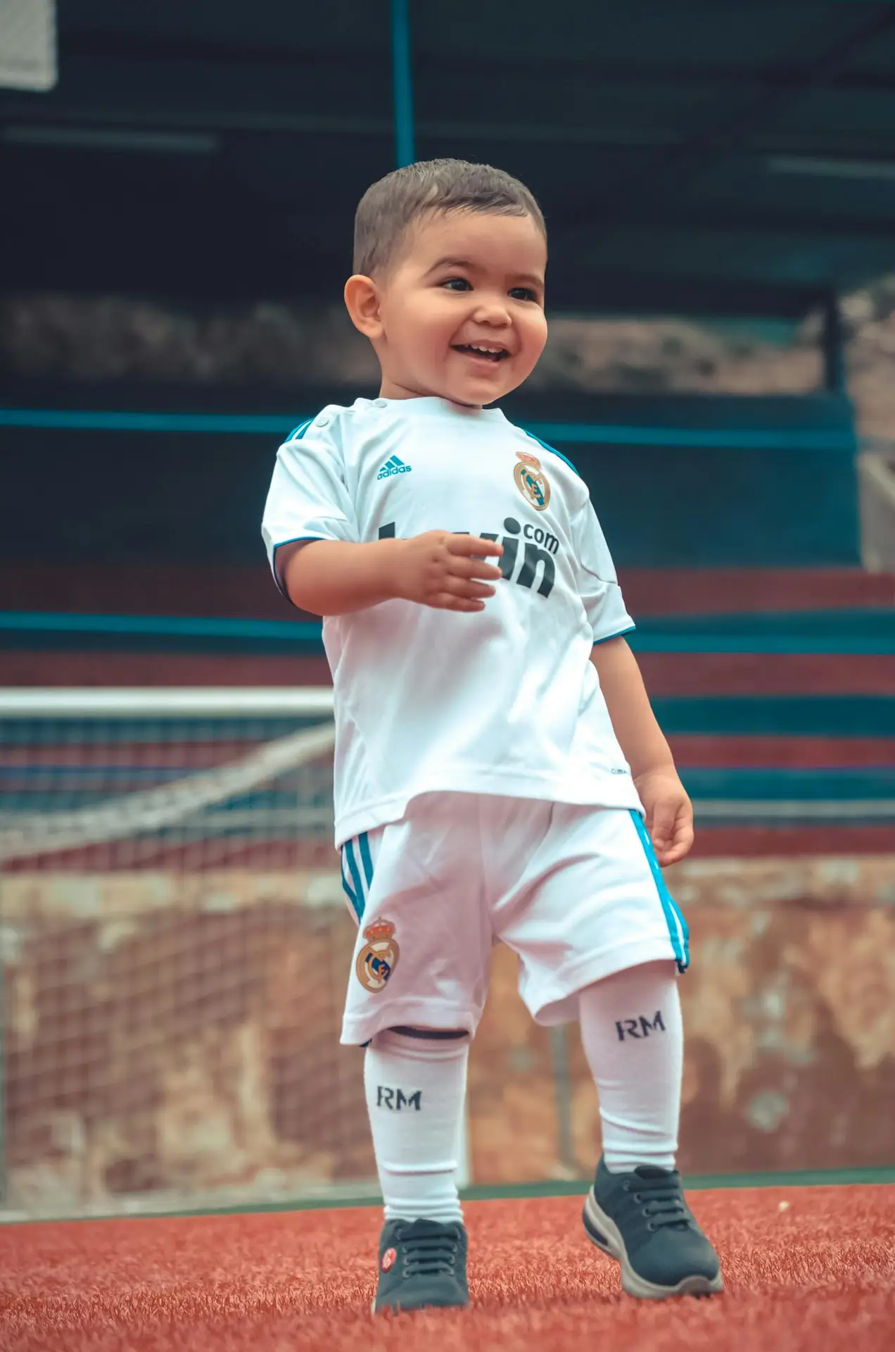 A joyful child in a soccer uniform enjoying a day on the football pitch.