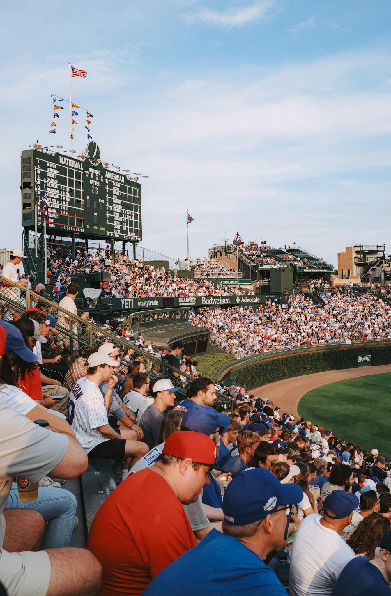 Fans gather at a packed baseball stadium on a sunny day, capturing sports excitement.